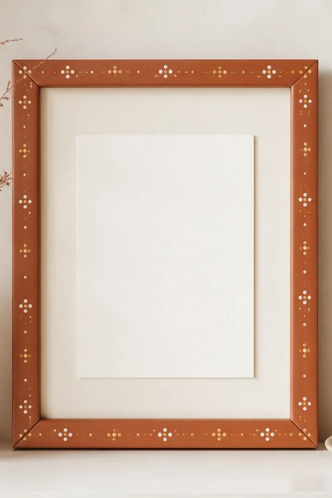 A terracotta-painted frame with tiny hand-painted dots in cream and muted gold. The backing is off-white, and the card is centered with plenty of space around it.